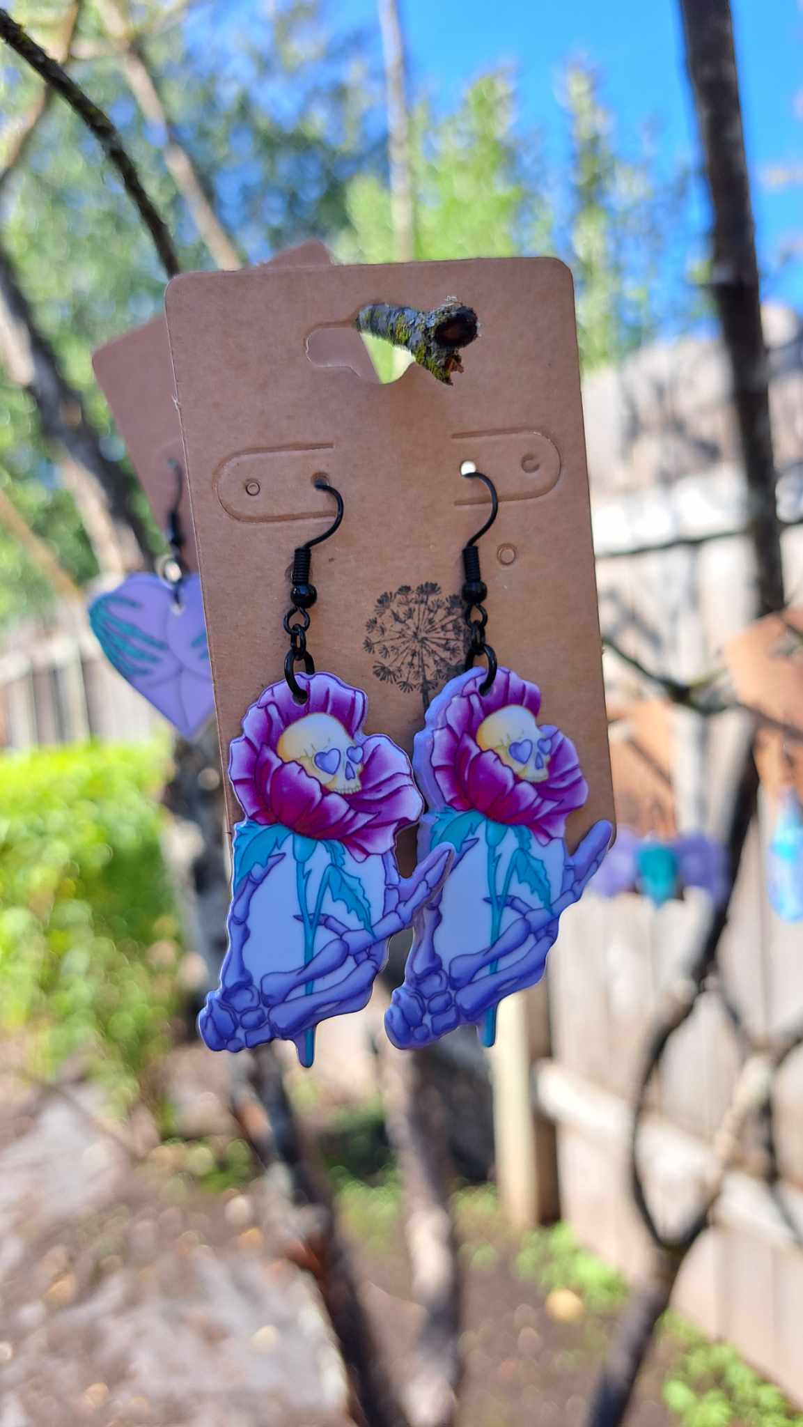 Acrylic Skeleton Hand Holding Flower Skull Earrings